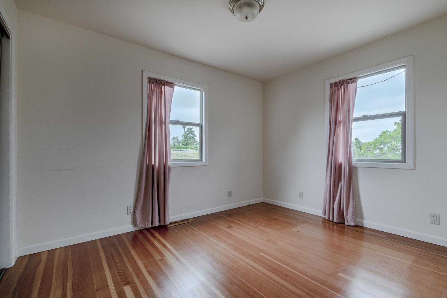 137 Whiting Road Watsonville, CA 95076 - Photo 17 of 52 an empty room with wooden floor and windows