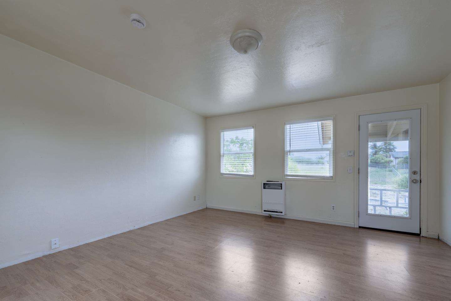 137 Whiting Road Watsonville, CA 95076 - Photo 19 of 52 an empty room with wooden floor and windows