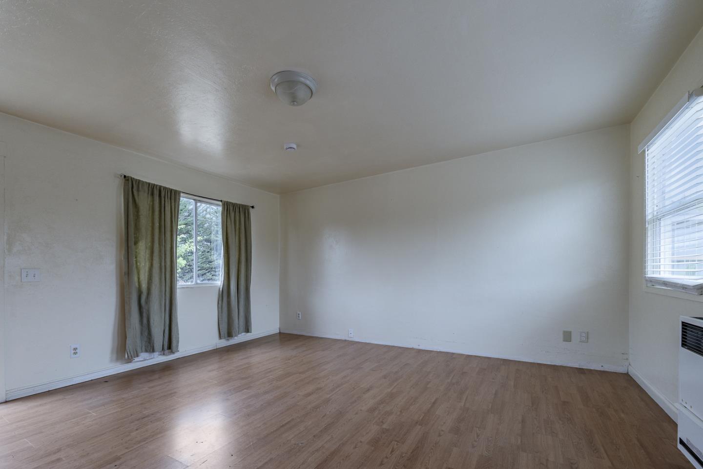 137 Whiting Road Watsonville, CA 95076 - Photo 20 of 52 an empty room with wooden floor and windows