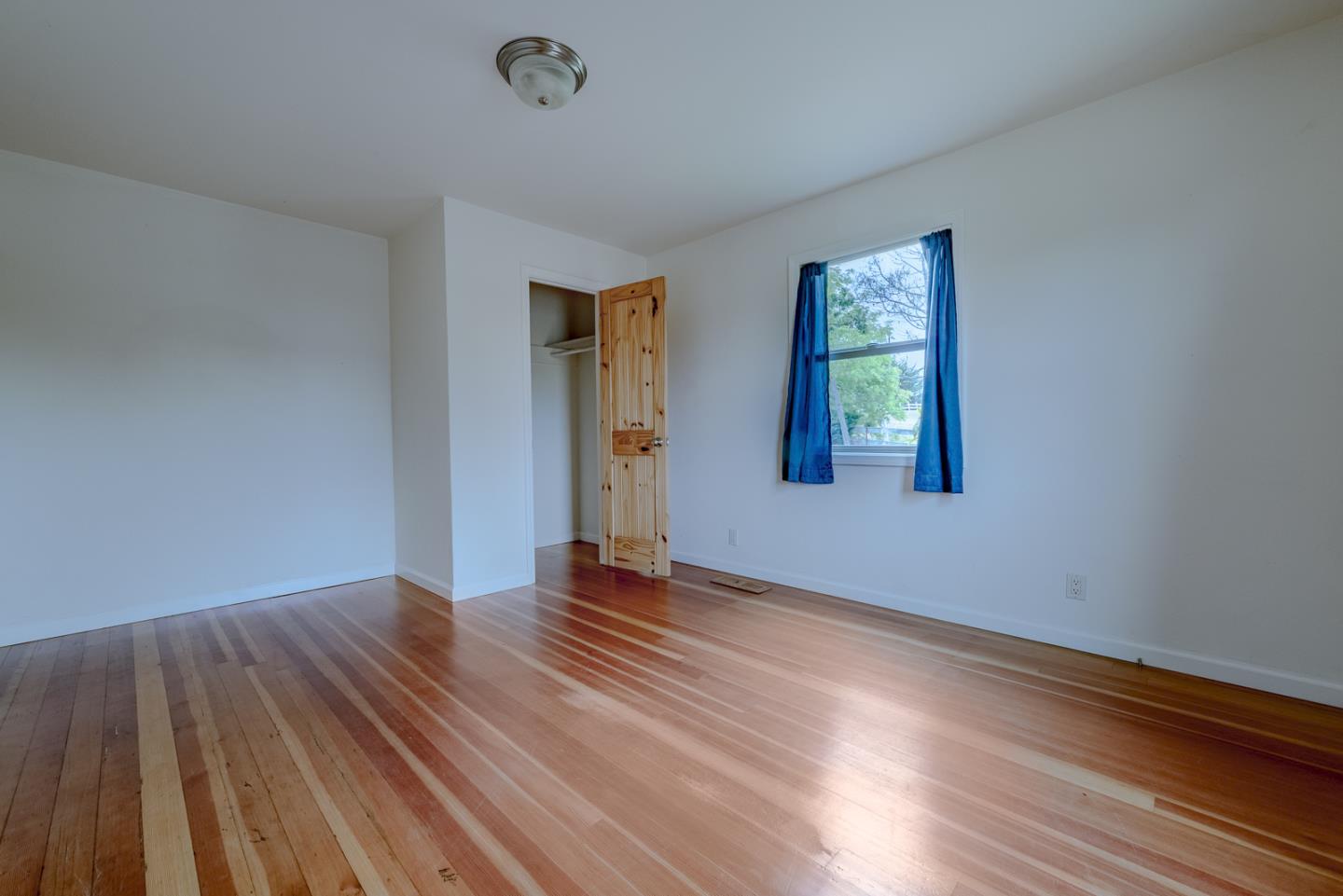 137 Whiting Road Watsonville, CA 95076 - Photo 21 of 52 a view of an empty room with wooden floor and a window