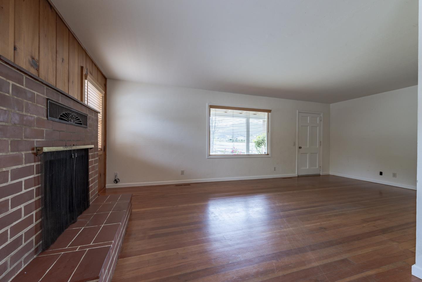 137 Whiting Road Watsonville, CA 95076 - Photo 7 of 52 an empty room with wooden floor and windows