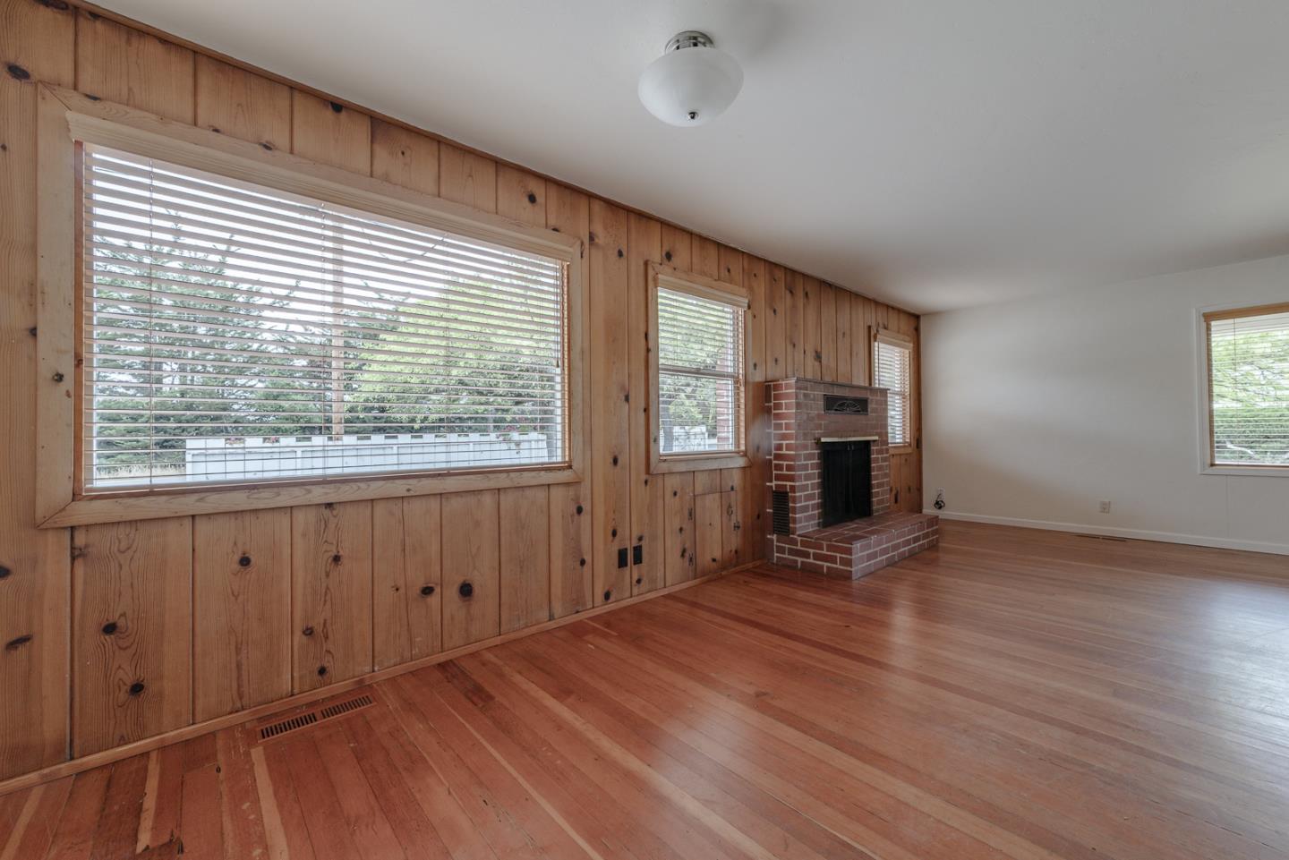137 Whiting Road Watsonville, CA 95076 - Photo 8 of 52 a view of empty room with a fireplace and wooden floor