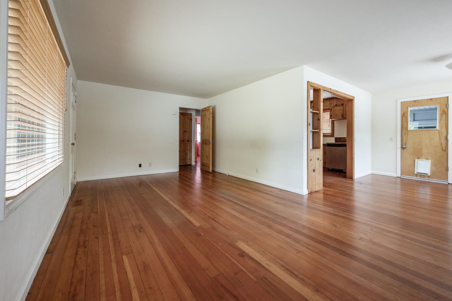 137 Whiting Road Watsonville, CA 95076 - Photo 9 of 52 an empty room with wooden floor and windows