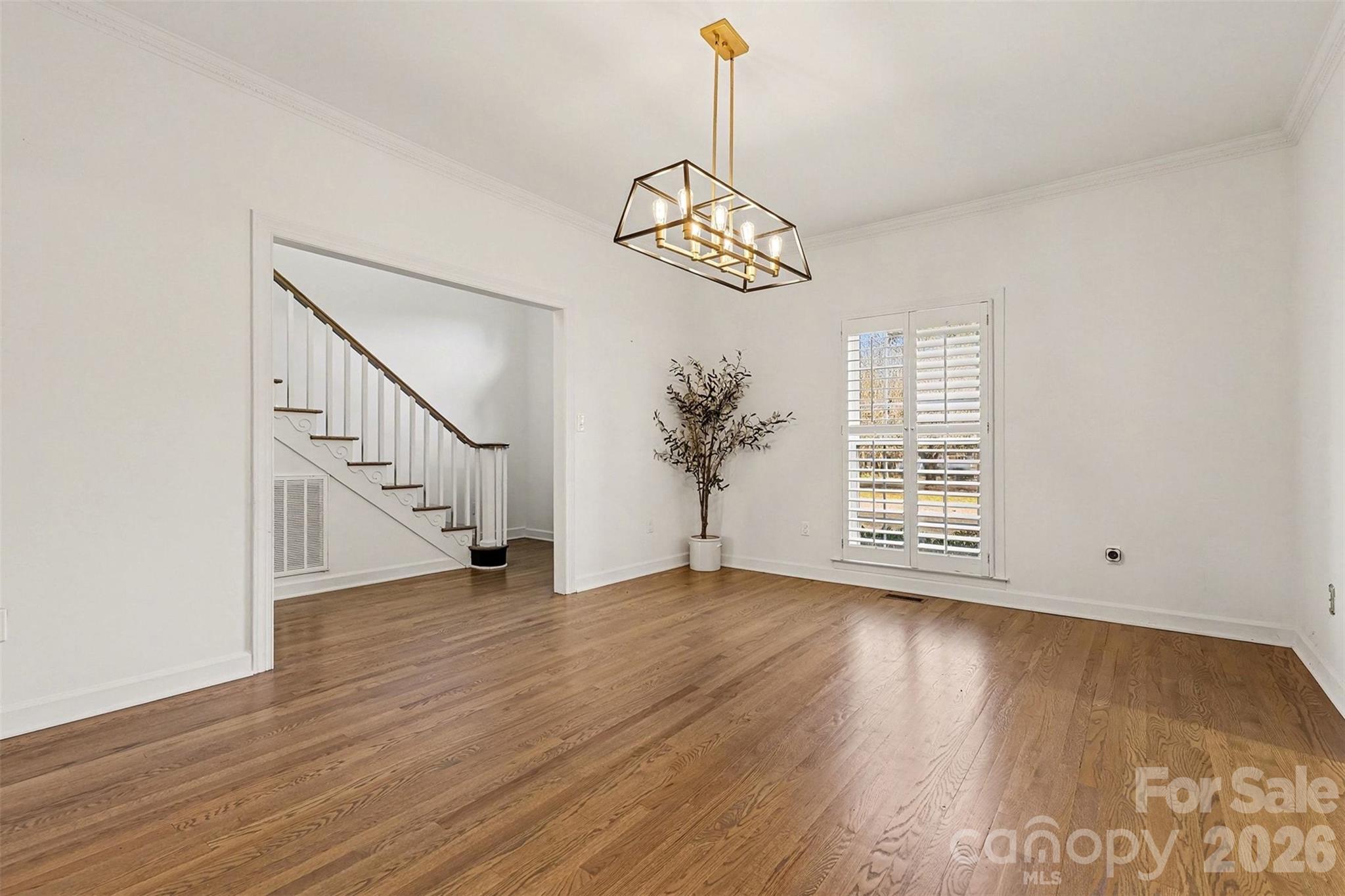 14320 Youngblood Road Charlotte, NC 28278 - Photo 15 of 41 a view of an empty room with wooden floor windows and a chandelier