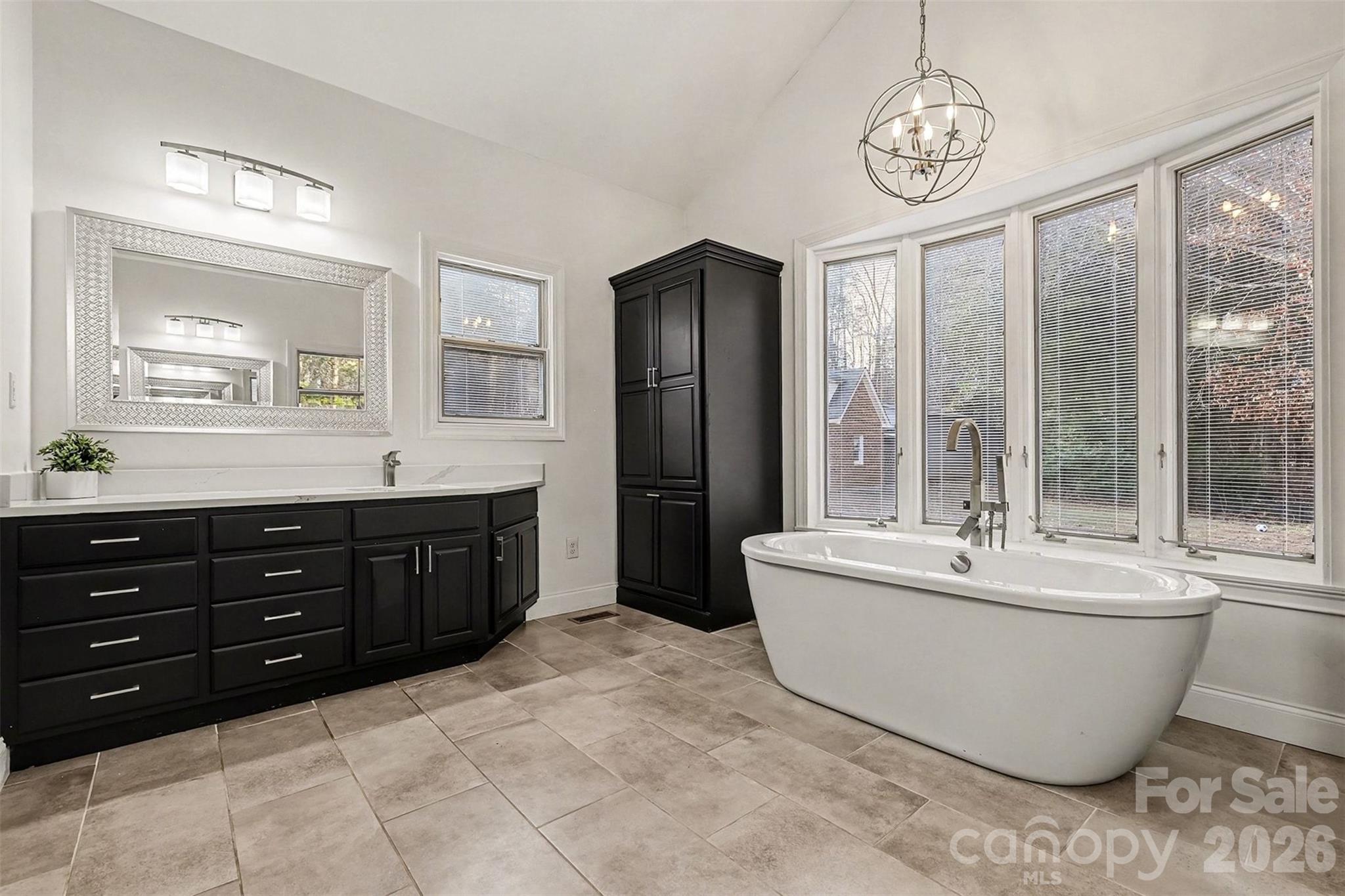 14320 Youngblood Road Charlotte, NC 28278 - Photo 20 of 41 a spacious bathroom with a tub sink and mirror
