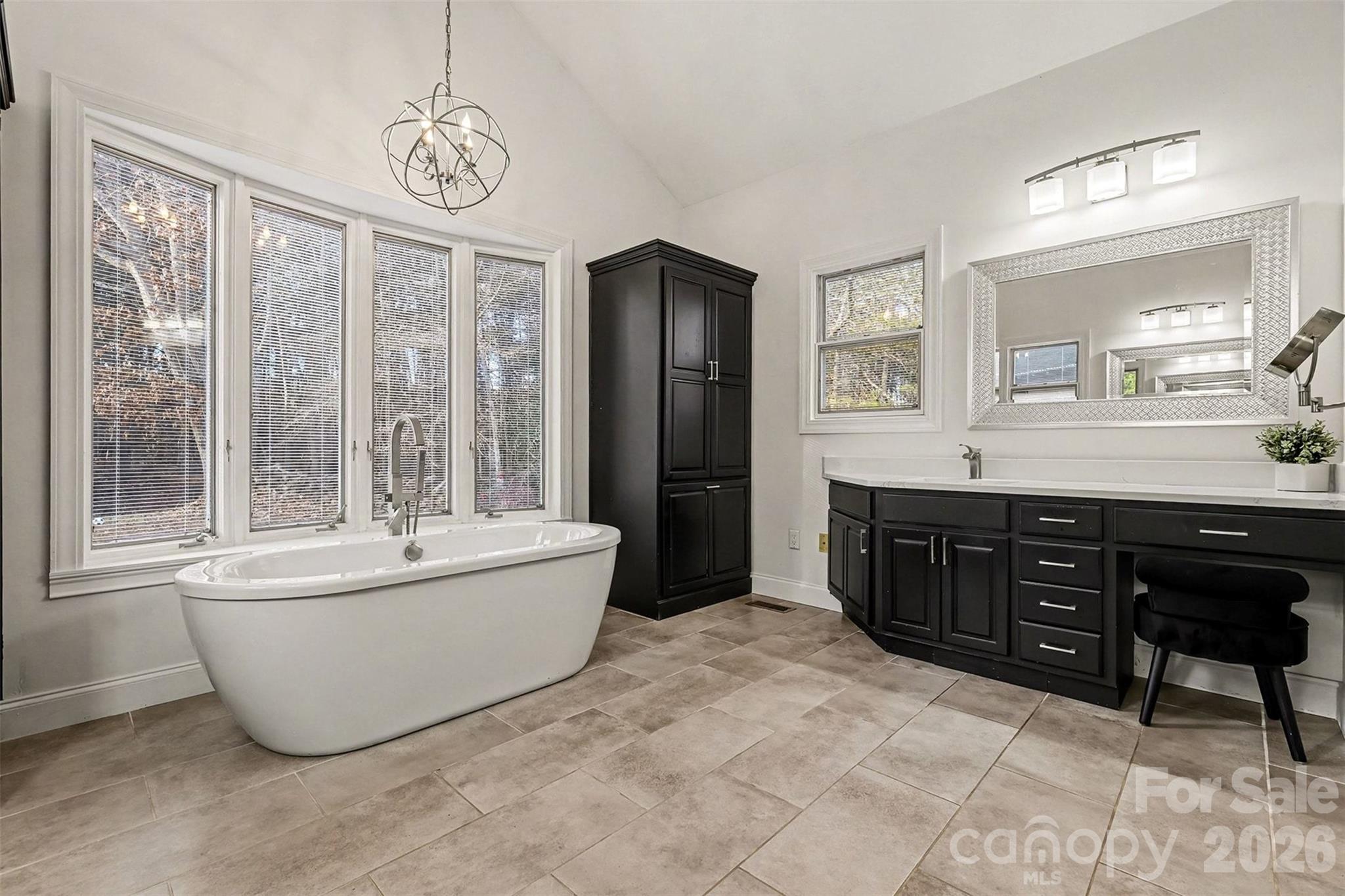 14320 Youngblood Road Charlotte, NC 28278 - Photo 22 of 41 a spacious bathroom with a tub sink and mirror