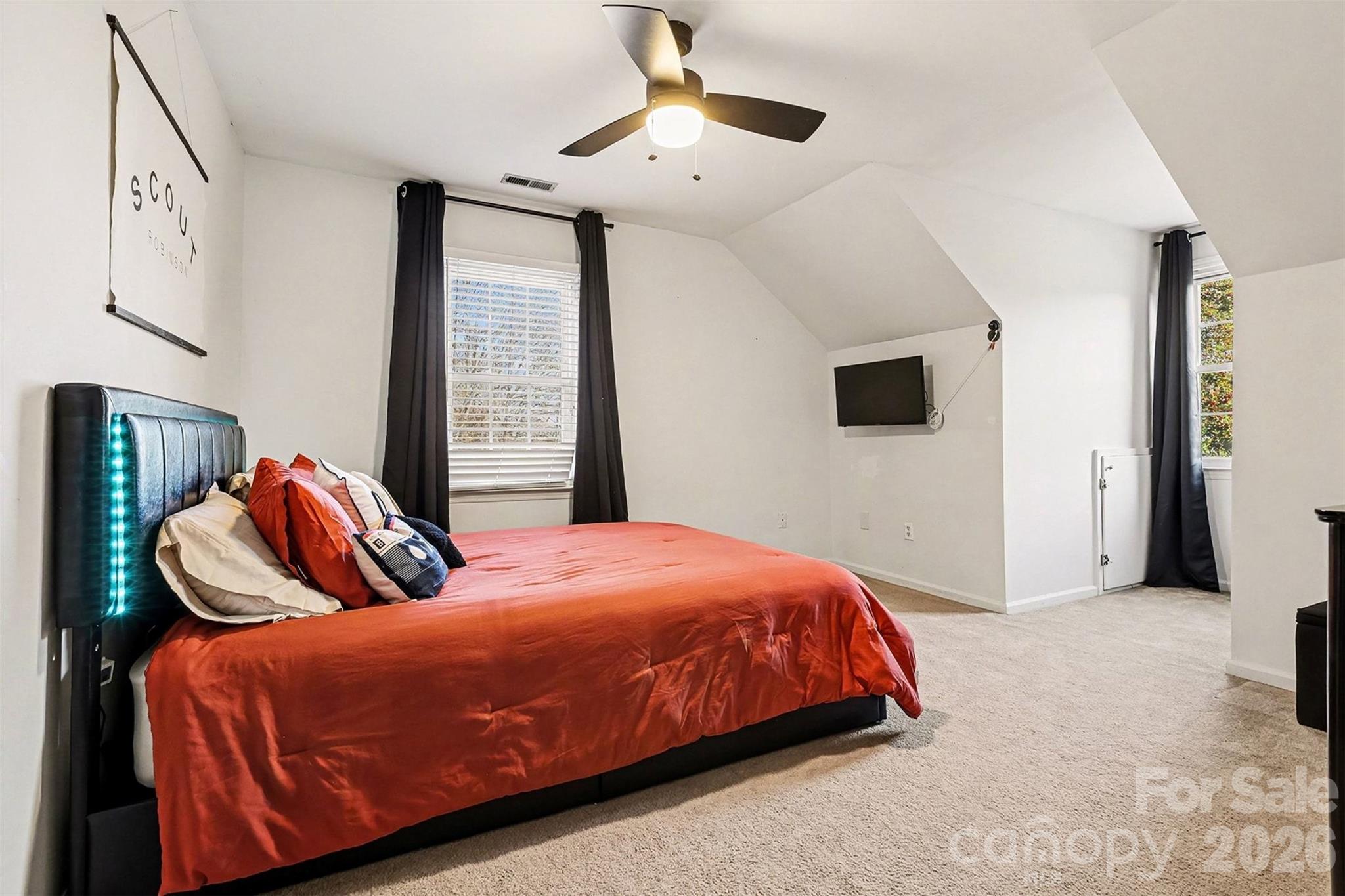 14320 Youngblood Road Charlotte, NC 28278 - Photo 30 of 41 a bedroom with a bed and a chandelier