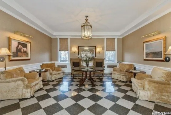 a living room with furniture and a chandelier
