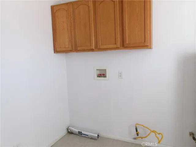 a view of storage and utility room with racks on the wall