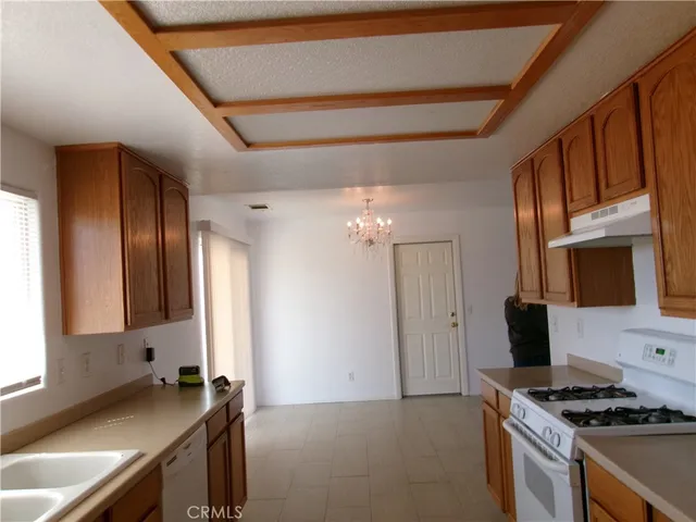a kitchen with granite countertop a stove and a sink