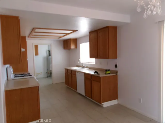 a kitchen with stainless steel appliances granite countertop a sink and a stove top oven