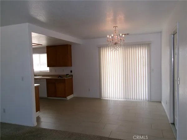 an empty room with windows and flat screen tv