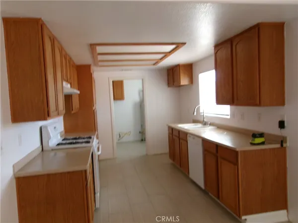 a kitchen that has a sink and a stove in it