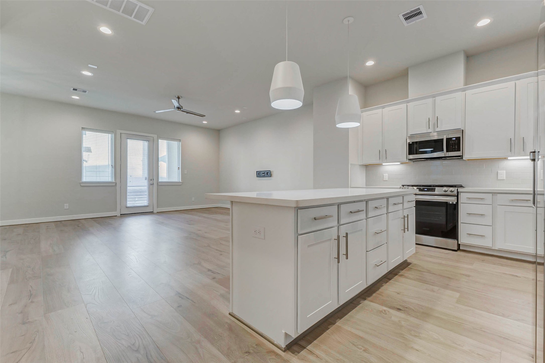 6313 Nelson Falls Lane Houston, TX 77008 - Photo 34 of 34 a kitchen with stainless steel appliances white cabinets a sink and a stove