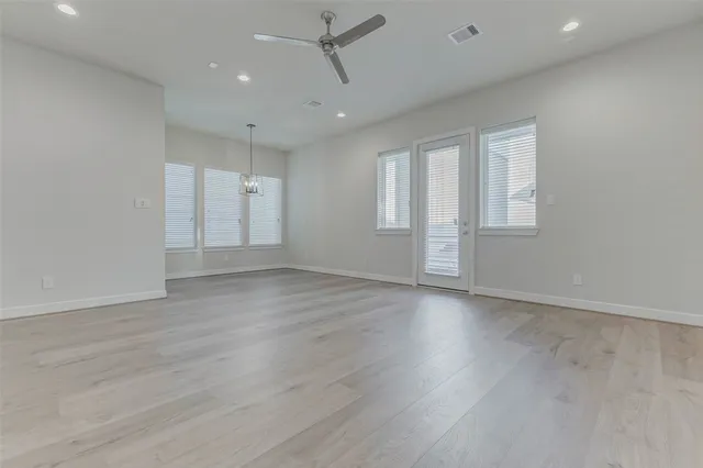 a kitchen with stainless steel appliances white cabinets a sink and a stove