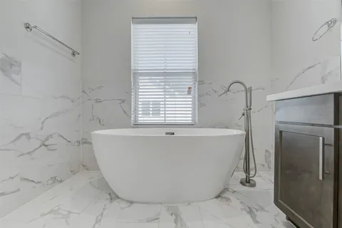 a white bath tub sitting in a bathroom
