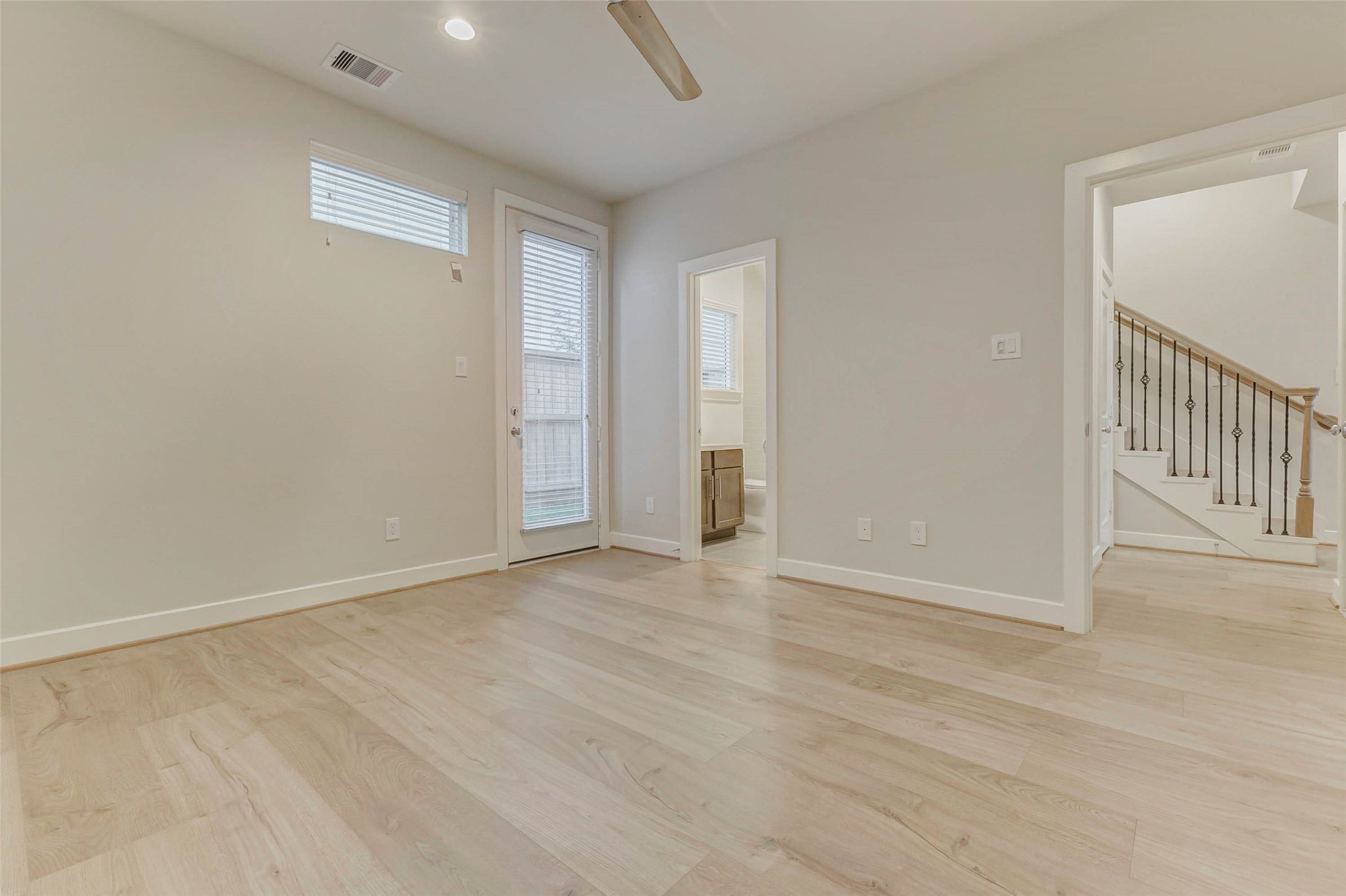 6313 Nelson Falls Lane Houston, TX 77008 - Photo 6 of 34 an empty room with wooden floor and windows