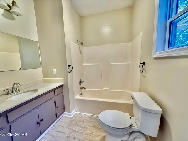 a view of a kitchen with furniture and a window