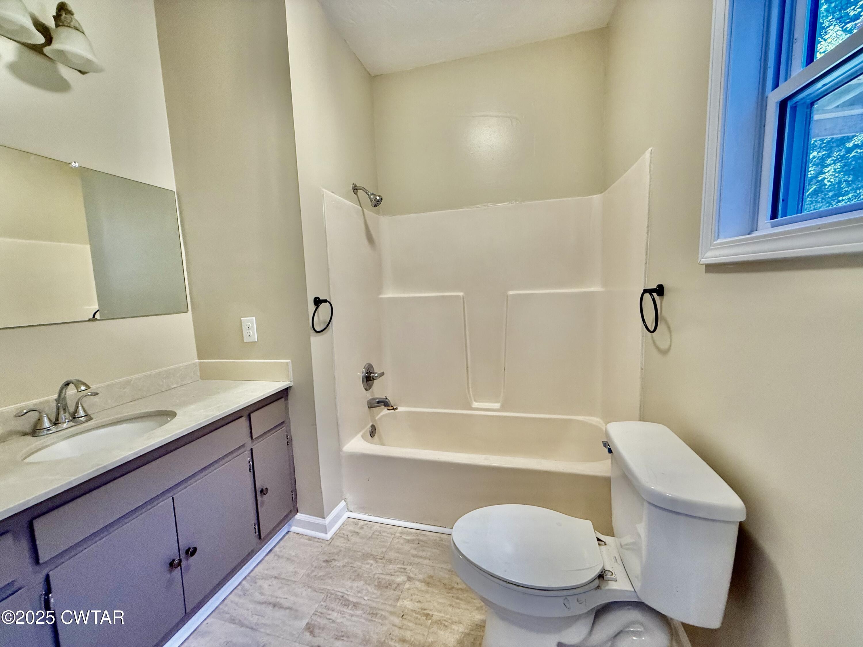 609 West Westbrook St Extension Troy, TN 38260 - Photo 12 of 16 a bathroom with a sink toilet a mirror and shower