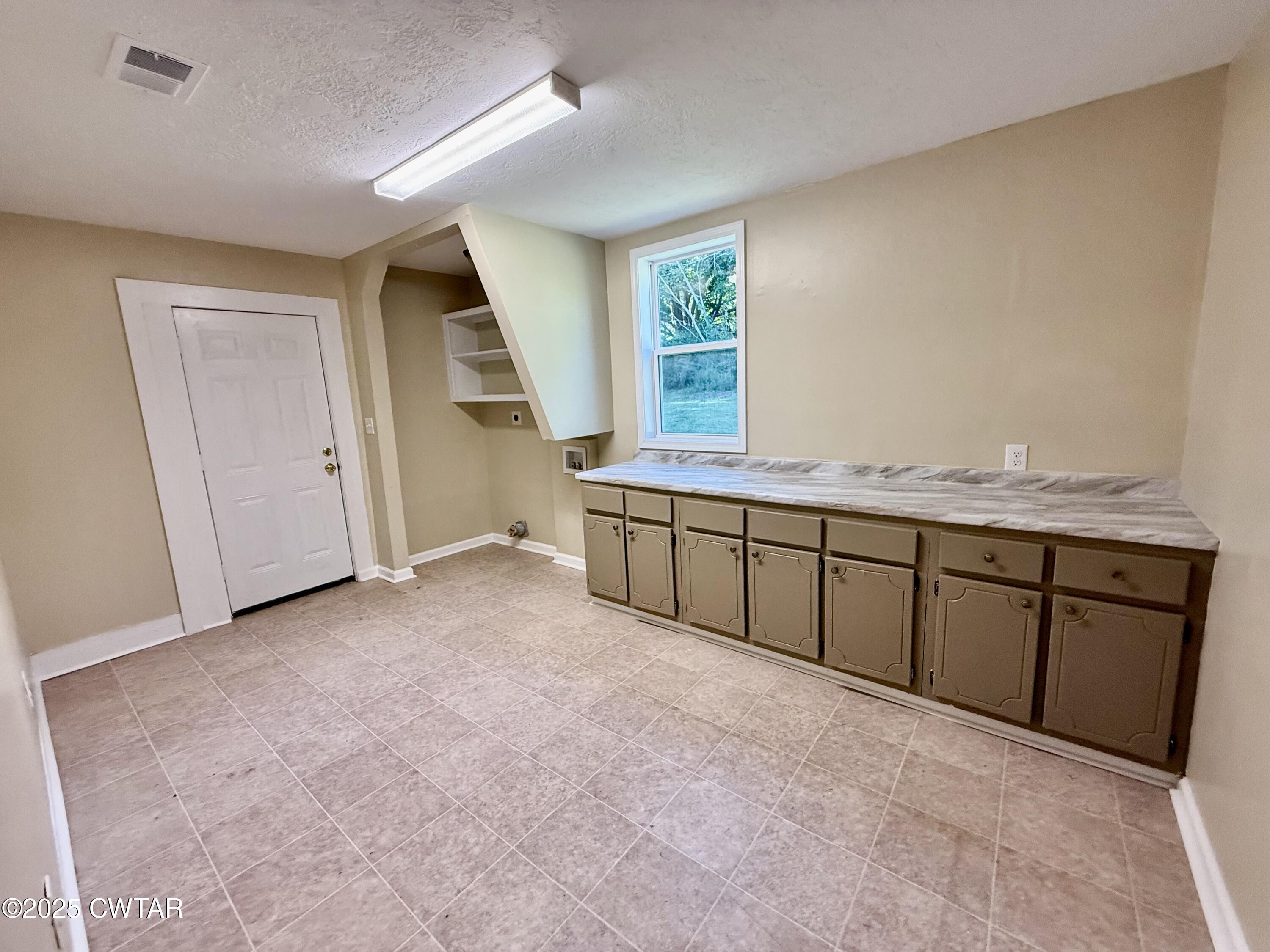 609 West Westbrook St Extension Troy, TN 38260 - Photo 13 of 16 a view of a kitchen with furniture and a window