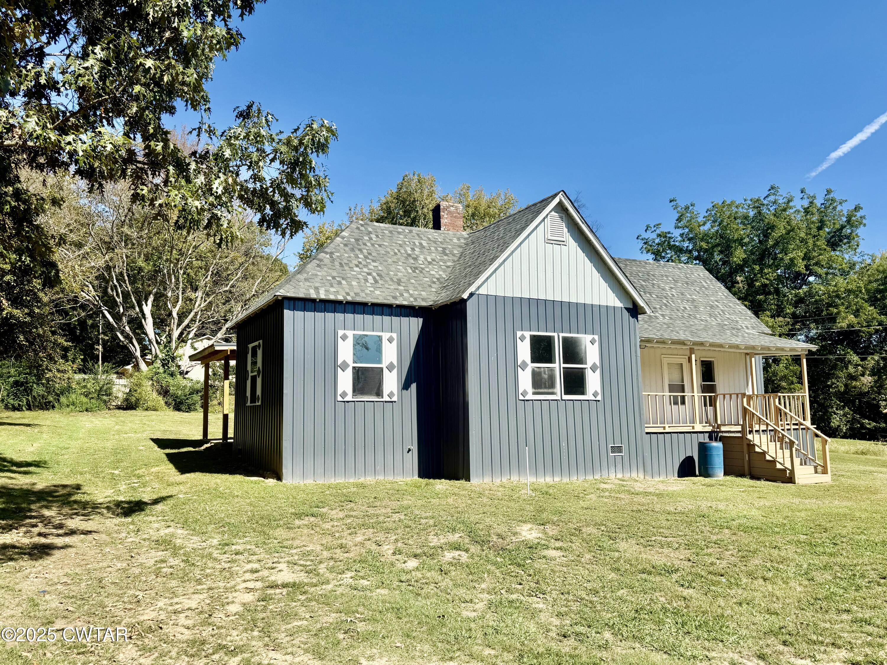 609 West Westbrook St Extension Troy, TN 38260 - Photo 16 of 16 a front view of a house with a yard