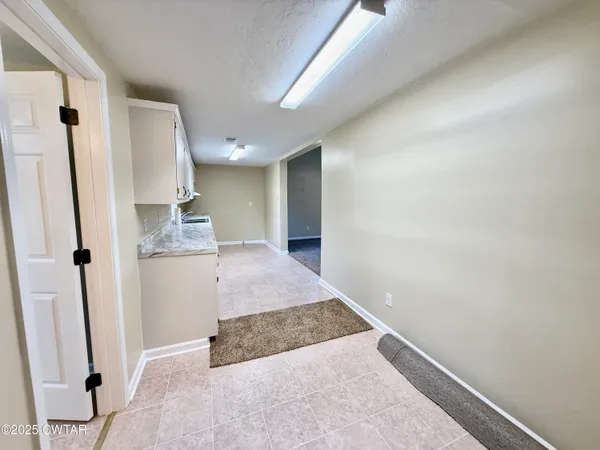 a view of kitchen with granite countertop cabinets