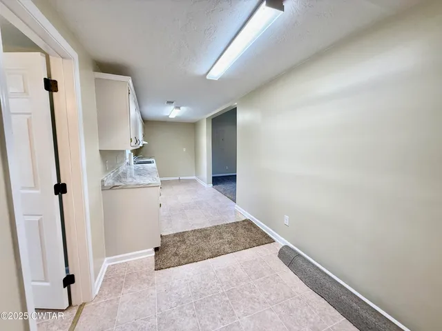 a view of kitchen with granite countertop cabinets