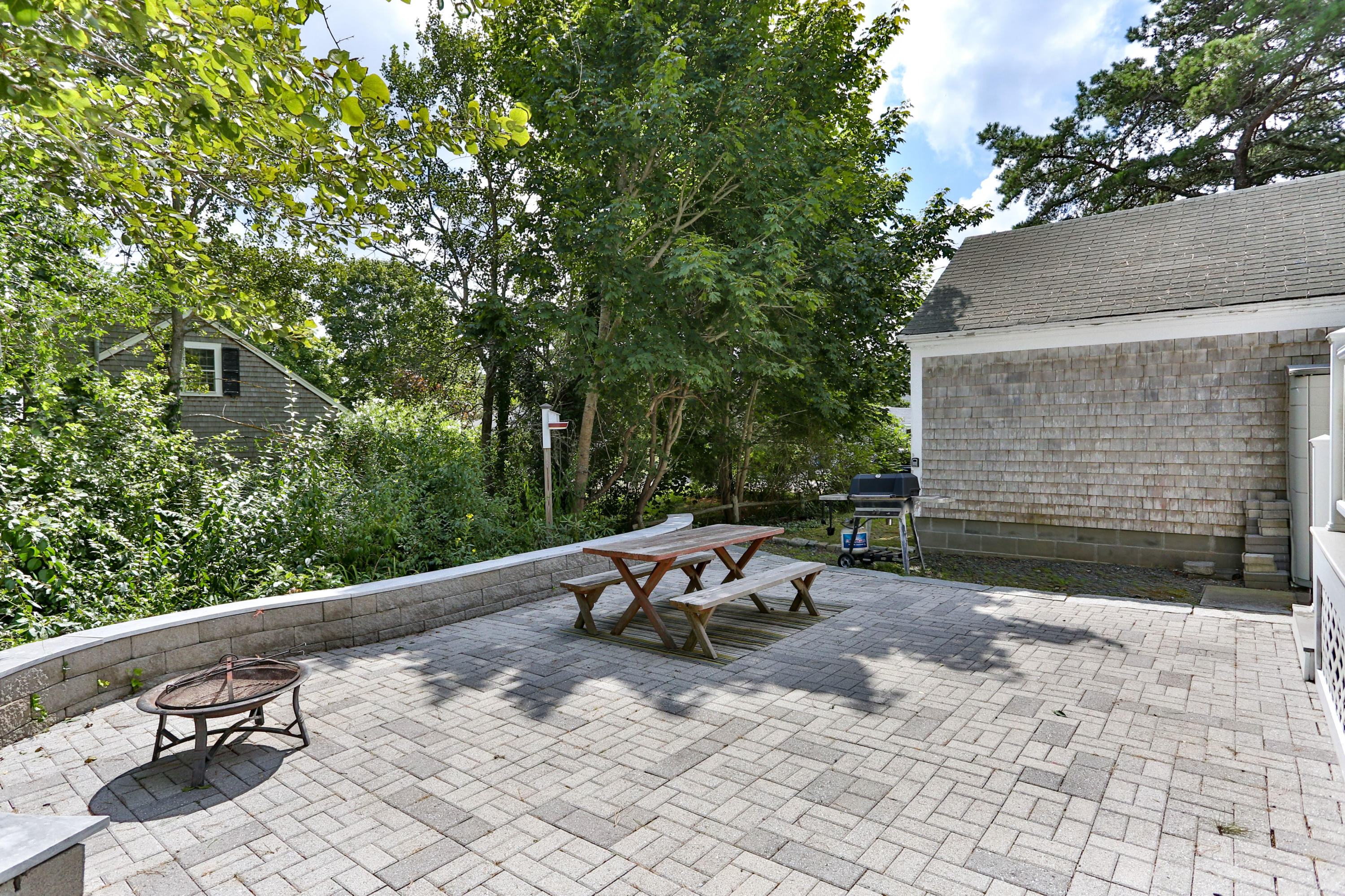 93 Brooks Road Harwich Port, MA 02646 - Photo 31 of 35 a backyard of a house with table and chairs