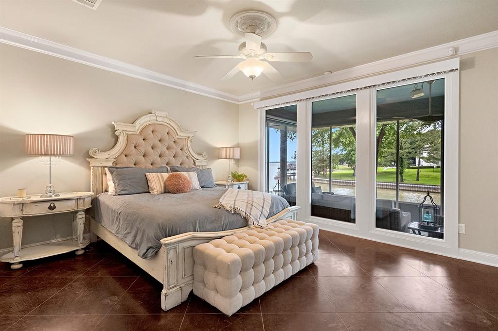 103 Glenn Road Mabank, TX 75156 - Photo 13 of 38 a spacious bedroom with a bed and a chandelier