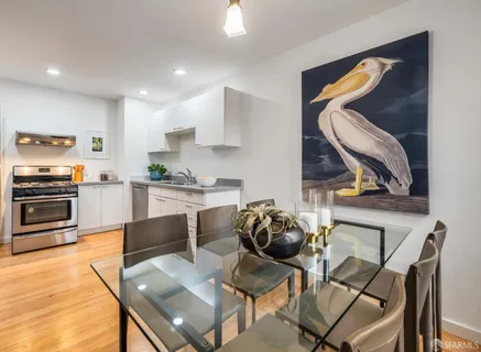 a kitchen with granite countertop a stove a sink and a refrigerator