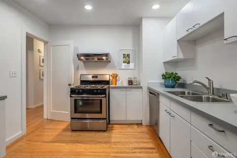 a kitchen with a sink and a stove top oven