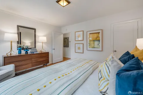 a bed room with a bed and a mirror