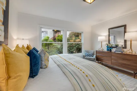 a bed room with a bed window and a dresser