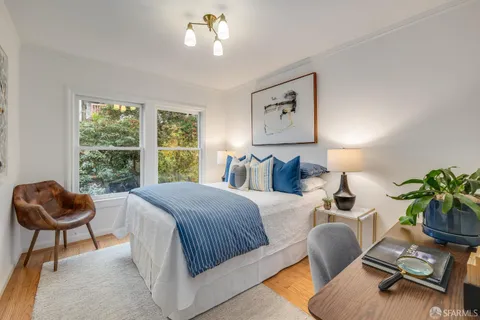 a bed room with a bed and a chair