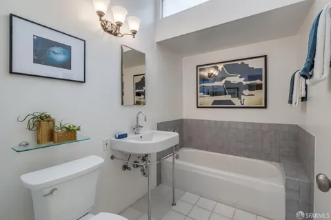 a bathroom with a toilet a sink and bathtub