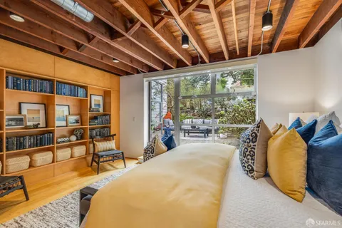 a bed room with furniture and a large window
