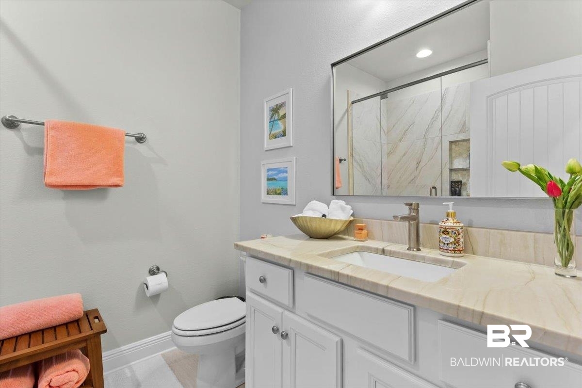 7056 Rocky Rd Loop Gulf Shores, AL 36542 - Photo 26 of 41 Bathroom with vanity and a marble finish shower