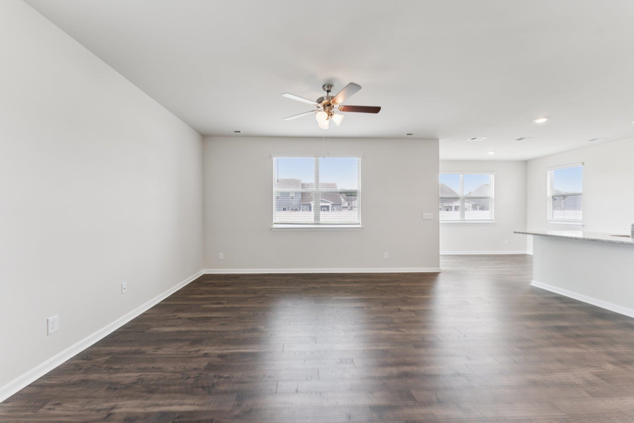 112 Meadow Ridge Way Staunton, VA 24401 - Photo 12 of 33 an empty room with wooden floor chandelier fan and windows