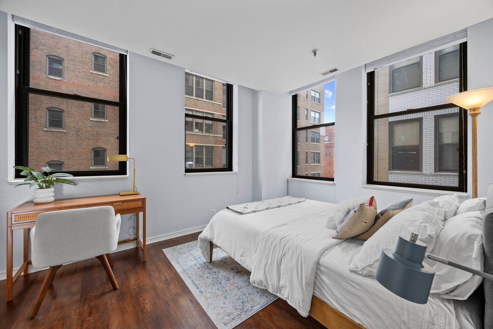 740 South Federal Street, Unit 710 Chicago, IL 60605 - Photo 13 of 23 a bedroom with a bed and wooden floor
