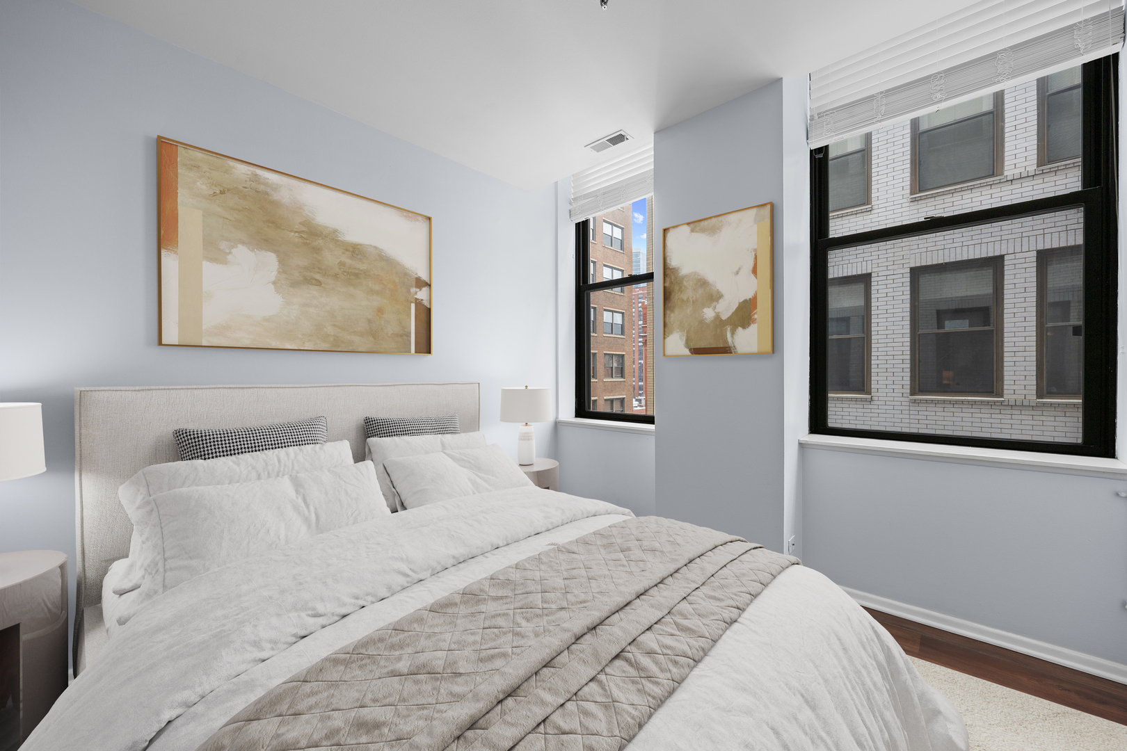 740 South Federal Street, Unit 710 Chicago, IL 60605 - Photo 17 of 23 a bedroom with a bed and a painting on the wall