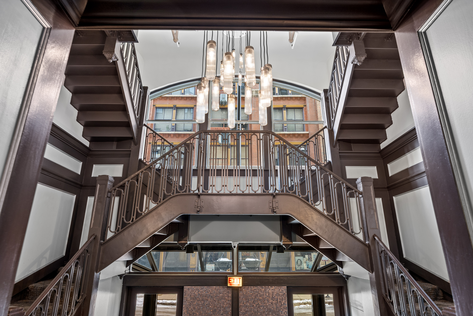 740 South Federal Street, Unit 710 Chicago, IL 60605 - Photo 2 of 23 a view of staircase with lots of frames on wall and windows