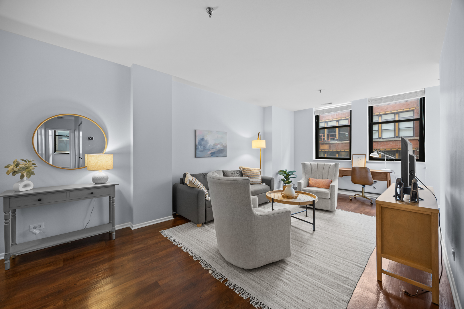 740 South Federal Street, Unit 710 Chicago, IL 60605 - Photo 4 of 23 a living room with furniture a flat screen tv and large windows