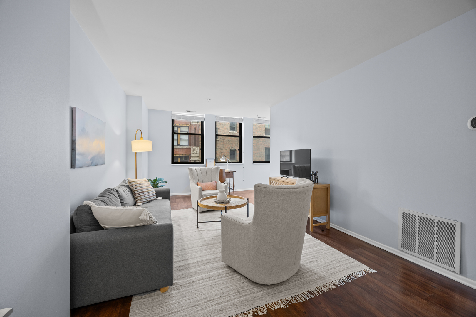 740 South Federal Street, Unit 710 Chicago, IL 60605 - Photo 6 of 23 a living room with furniture and a wooden floor
