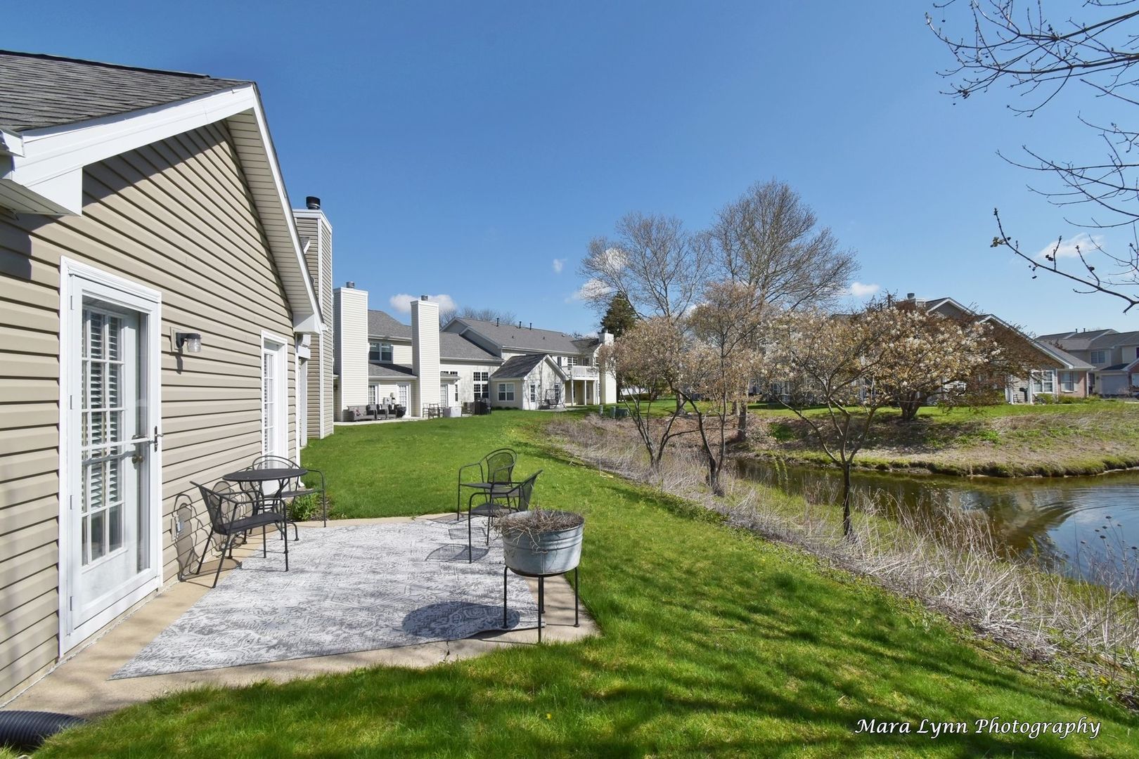 54 Jericho Lane Batavia, IL 60510 - Photo 26 of 29 a view of a lake with a house in the background