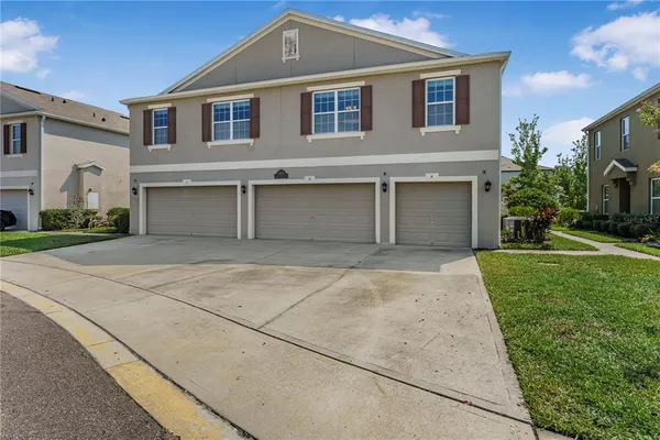 a front view of a house with a yard and garage