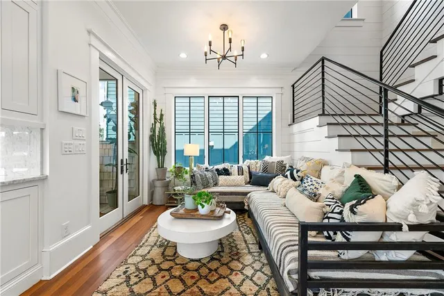 a living room with furniture and a potted plant
