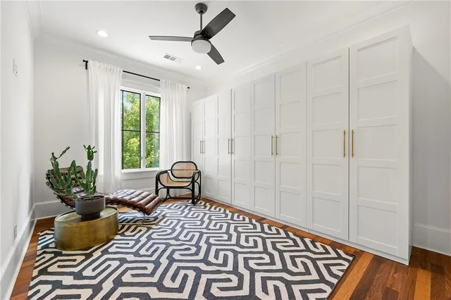 a living room with a rug and wooden floor