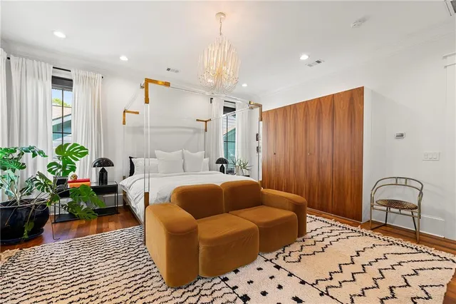 a bedroom with furniture and a potted plant