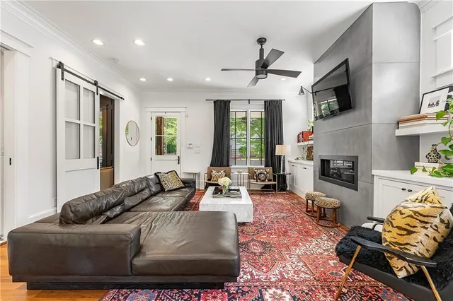 a living room with furniture fireplace and flat screen tv