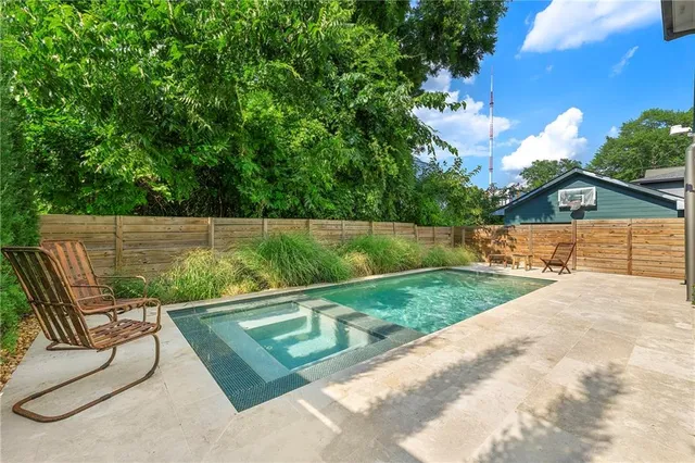 a view of backyard with outdoor seating and green space